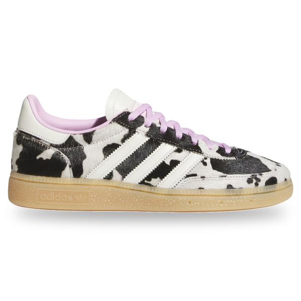Sneaker with cow print pattern on a white background