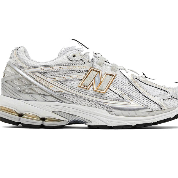White athletic shoe with gold accents on a white background