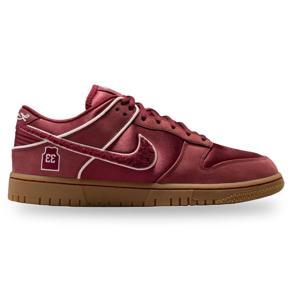 Red sneaker with a brown sole on a white background