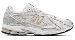 White athletic shoe with gold accents on a white background - Image 1