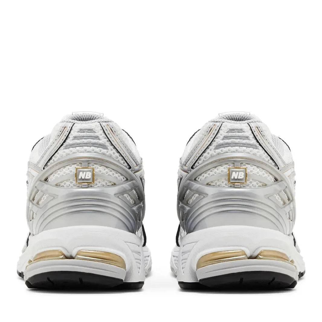 White and gold athletic shoes on a white background