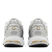 White and gold athletic shoes on a white background