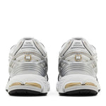 White and gold athletic shoes on a white background - Image 4