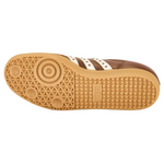 Close-up of a brown sneaker sole with white stripes on a white background - Image 5