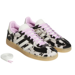 Pair of black and white cow print sneakers with pink laces on a white background - Image 2