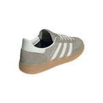 Gray Adidas sneaker with white stripes on a light gray background - Image 6