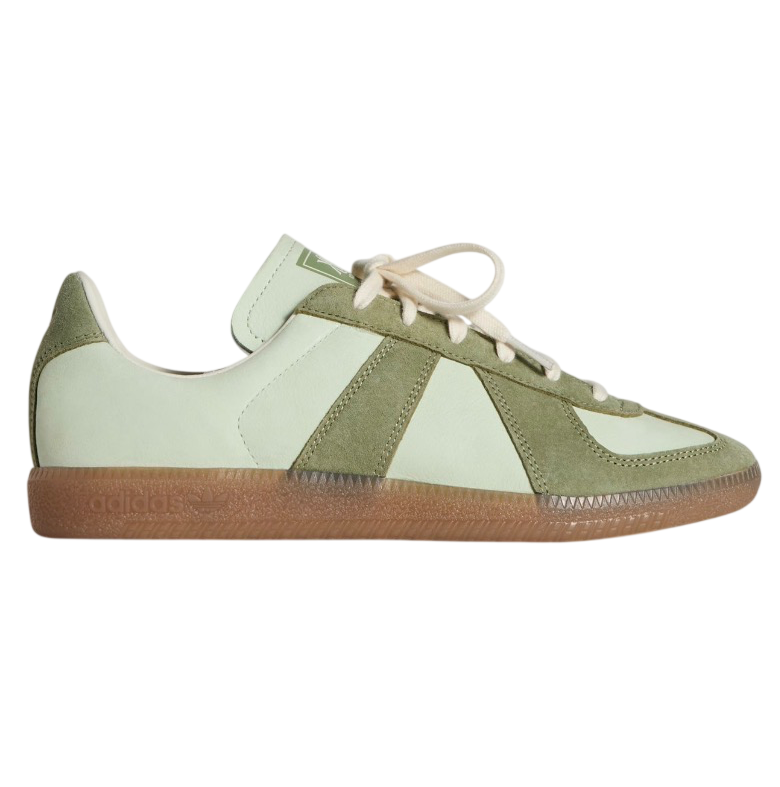 Green and white sneaker with brown sole on a white background