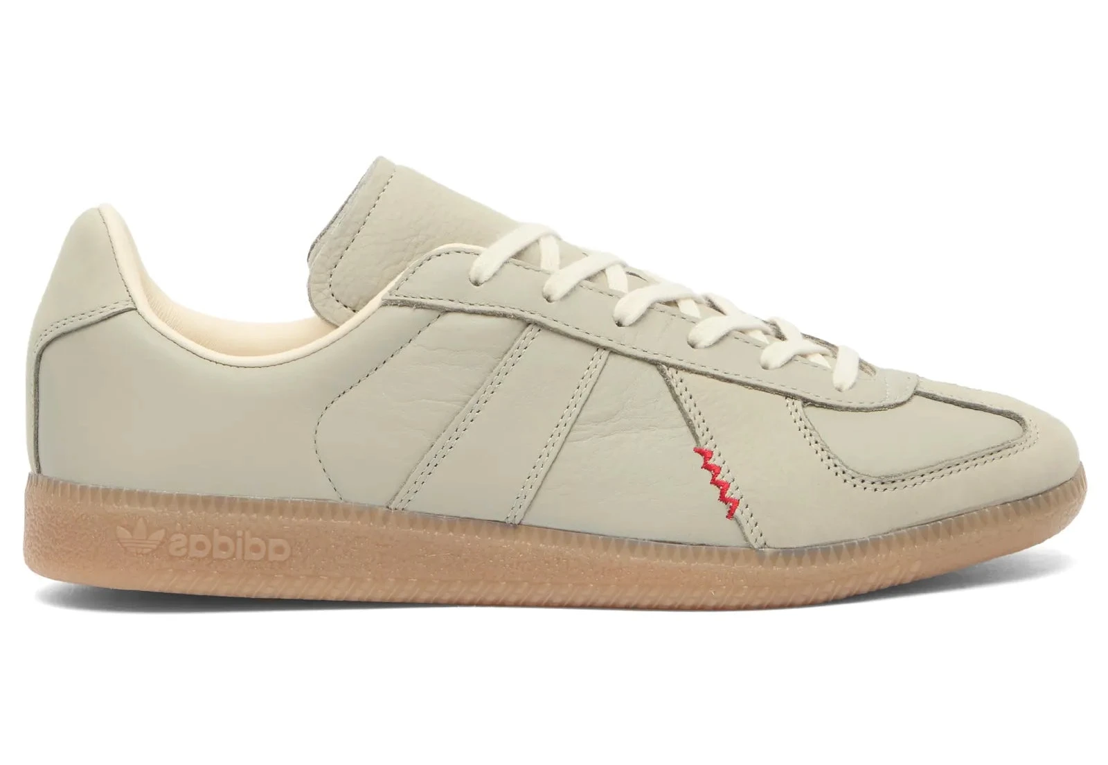 Beige Adidas sneaker with a red accent on a white background
