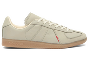 Beige Adidas sneaker with a red accent on a white background