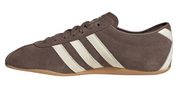 Brown sneaker with white stripes on a white background