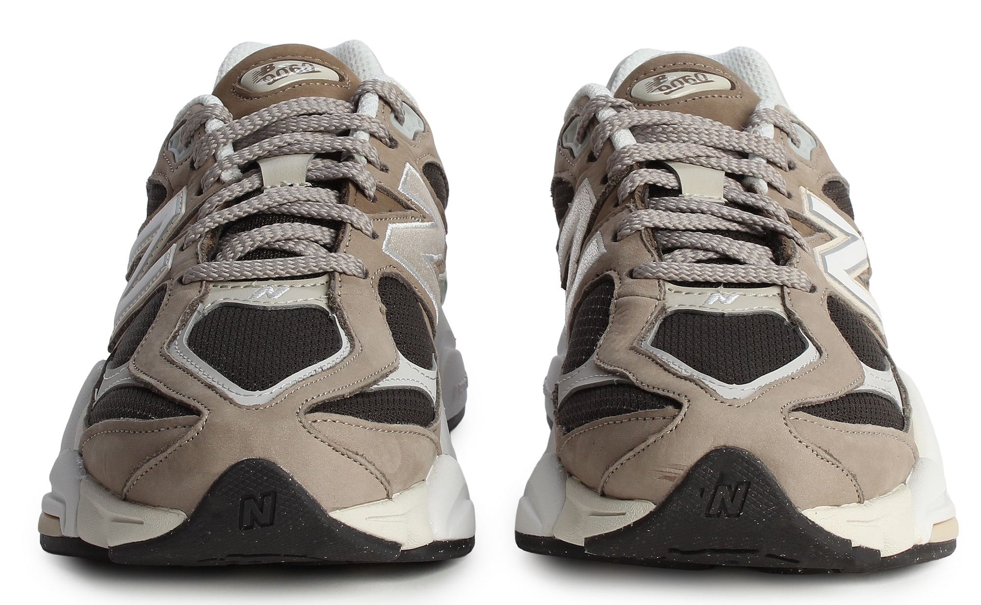 Pair of beige and black sneakers on a white background