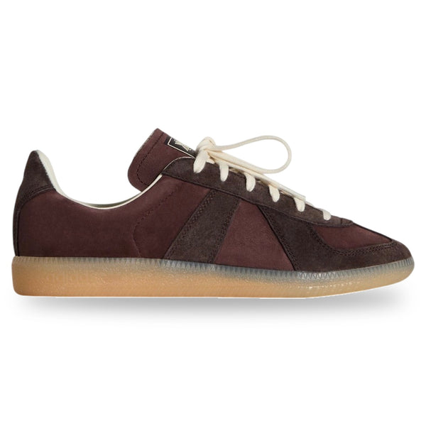 Brown sneaker with white laces on a light gray background
