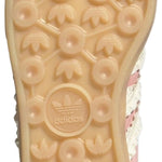 Close-up of a shoe sole with a brand logo on a light gray background - Image 5