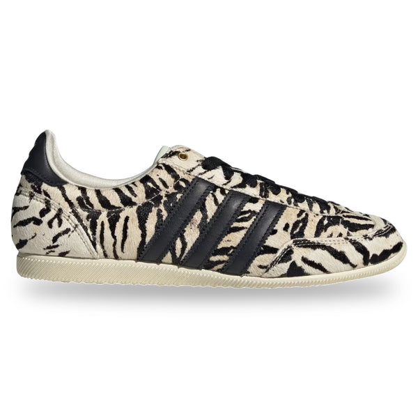 Zebra-patterned sneaker with black stripes on a white background