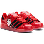 Red sneakers with black accents and a unique charm on a white background - Image 2