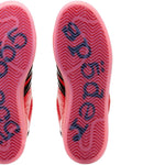 Close-up of red and black athletic shoes with brand logo on sole against a white background - Image 5