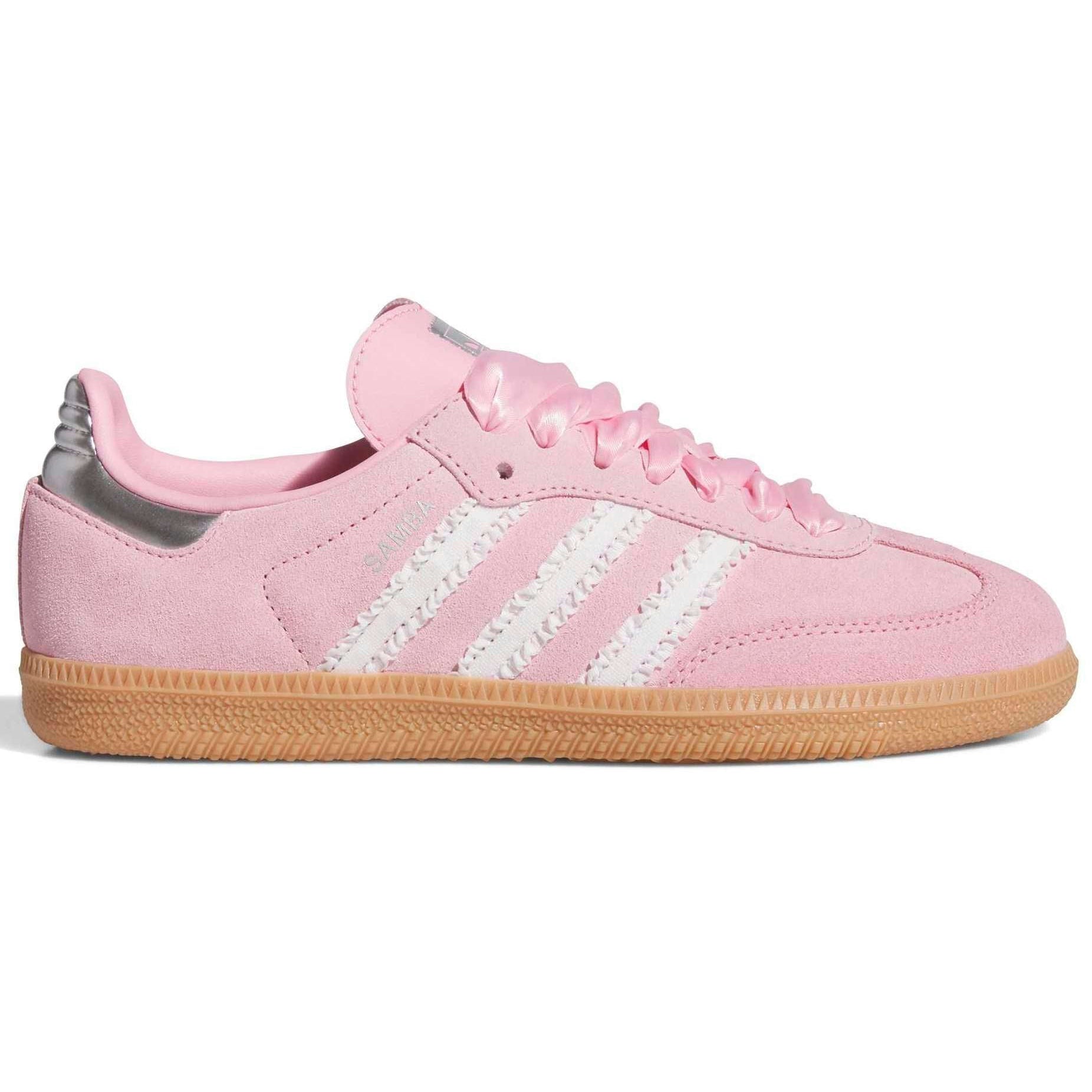 Pink Adidas sneaker with white stripes on a white background