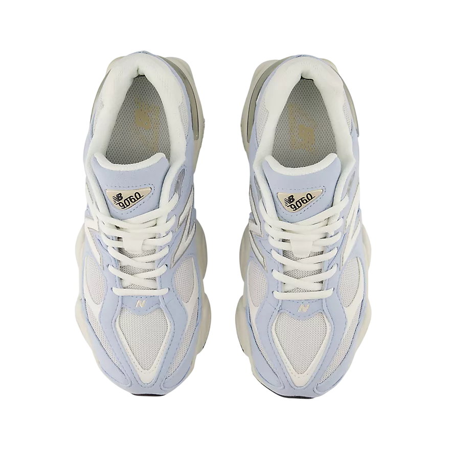 Pair of light blue and white sneakers on a white background