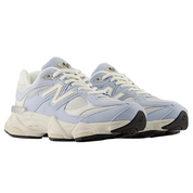 Light blue sneakers with white laces on a white background