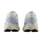 Pair of white sneakers with light blue accents on a white background