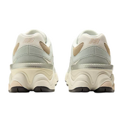 Pair of light gray sneakers with New Balance logo on a white background