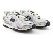 Pair of white New Balance sneakers with black accents on a white background
