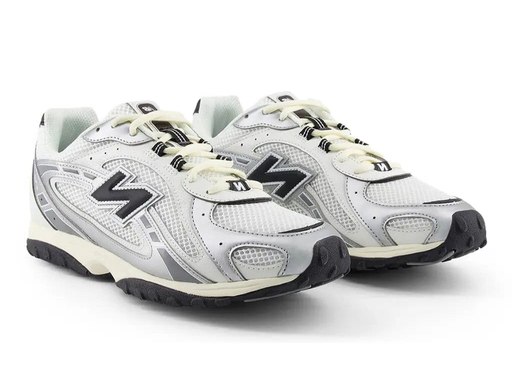 Pair of white New Balance sneakers with black accents on a white background
