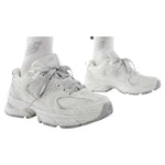 White sneakers worn with white socks on a white background - Image 2