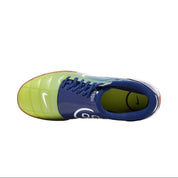 Blue and green soccer shoe on a white background