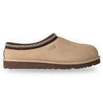 Beige UGG slipper with brown trim on a white background - Image 1