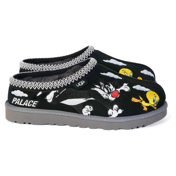 Black slippers with cartoon character design and 'Palace' branding on a white background