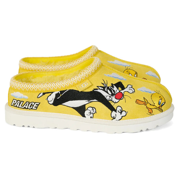 Yellow slippers with cartoon characters and 'Palace' branding on a white background